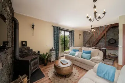 a living room with a couch and a fireplace at Casa de Campo Arco de São Jorge by An Island Apart in Santana