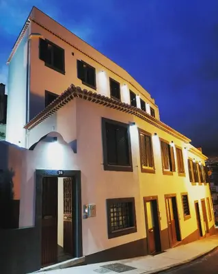 a large yellow and white building with a door at Apartments Madeira Funchal City in Funchal