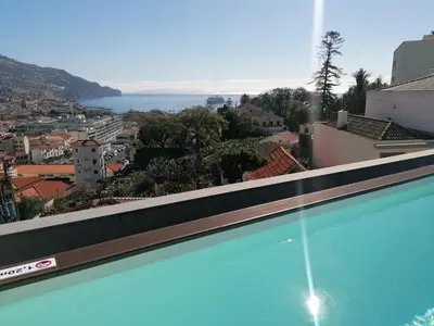 a swimming pool with a view of a city at Apartments Madeira Funchal City in Funchal