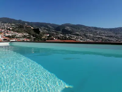a large pool of water with a city in the background at Apartments Madeira Funchal City in Funchal