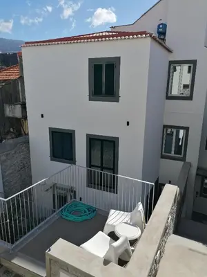 a balcony with white furniture on a white building at Apartments Madeira Funchal City in Funchal