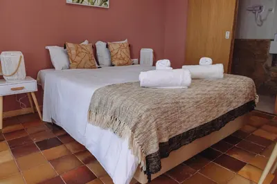 a bedroom with a large bed with towels on it at Porto Santo Destination in Porto Santo