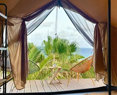 a tent with a table and chairs on a deck at Porto Santo Destination in Porto Santo