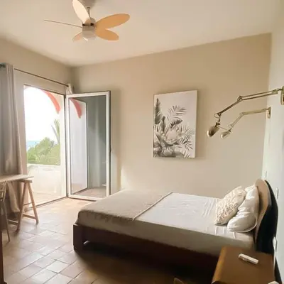 a bedroom with a bed and a ceiling fan at Porto Santo Destination in Porto Santo
