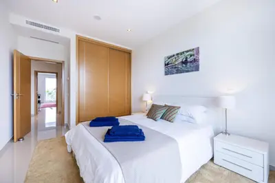 a white bedroom with two beds in it at CoolHouses Algarve Lagos, 3 Bed modern Flat, outdoor & Indoor pools, Gym, Amor à Vida in Lagos