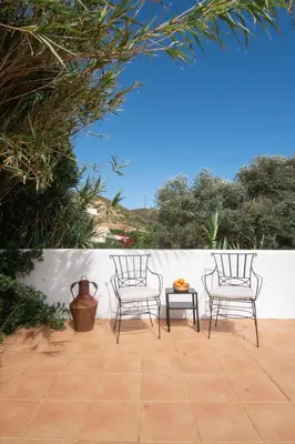 two chairs and a table on a patio at Casa Almargens in Aljezur by Lisbeyond in Bordeira