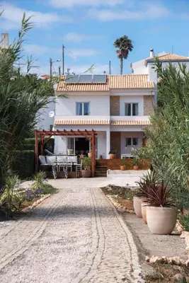 a large white house with a patio in front of it at Casa Almargens in Aljezur by Lisbeyond in Bordeira