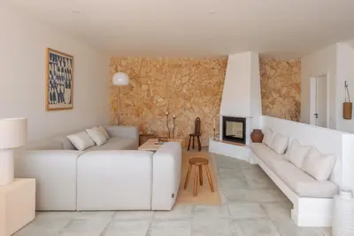 a living room with two white couches and a fireplace at Casa Almargens in Aljezur by Lisbeyond in Bordeira