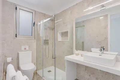 a bathroom with a toilet and a sink and a shower at Luxury Villa Bianca by Holiday Rental Madeira in Arco da Calheta