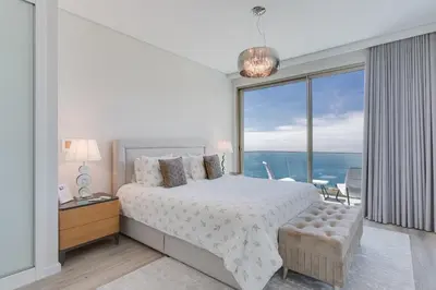 a bedroom with a bed and a large window at Luxury Villa Bianca by Holiday Rental Madeira in Arco da Calheta