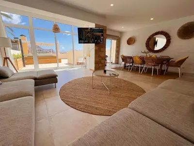 a living room with a couch and a table at Casa da Pedreira in Porto Santo