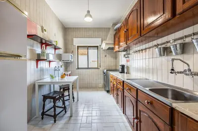 a small kitchen with a sink and a table at Cabo de Sagres -2 bedroom apartment in Sagres