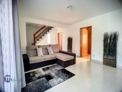 a living room with a couch and a staircase at Casa do Romaninho in Porto da Cruz