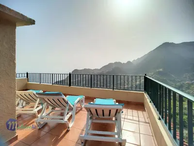 two chairs and a table on a balcony with a view at Casa do Romaninho in Porto da Cruz