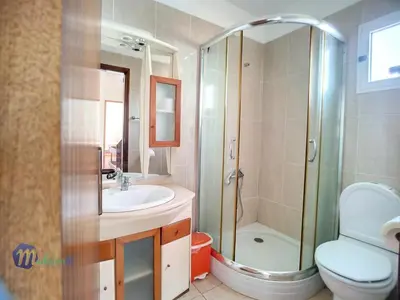 a bathroom with a shower and a sink and a toilet at Casa do Romaninho in Porto da Cruz
