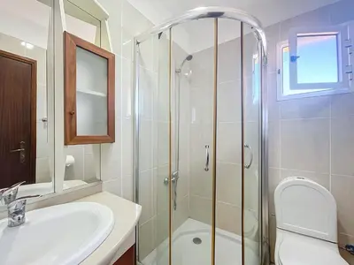 a bathroom with a shower and a sink and a toilet at Casa do Romaninho in Porto da Cruz