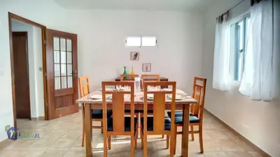 a dining room with a wooden table and chairs at Casa do Romaninho in Porto da Cruz