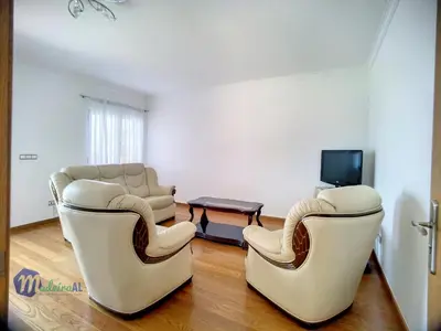 a living room with two chairs and a tv at Yohanna's accommodation in Campanário