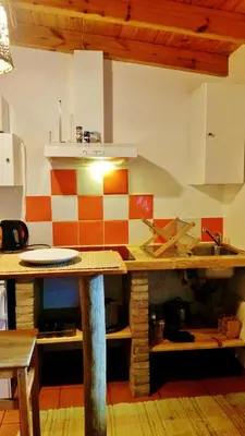 a kitchen with a table and a sink in it at PuraVida Divehouse in Sagres