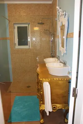 a bathroom with a sink and a mirror and a tub at PuraVida Divehouse in Sagres