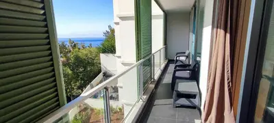a balcony with chairs and a view of the ocean at Lindas Holiday Apartment in Funchal