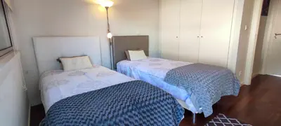 two beds sitting next to each other in a room at Lindas Holiday Apartment in Funchal
