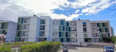 a large apartment building with cars parked in a parking lot at Lindas Holiday Apartment in Funchal