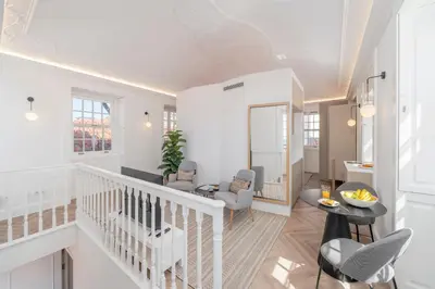 a living room with a staircase and chairs and a table at FAA Belas Artes by An Island Apart in Funchal