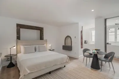 a bedroom with a bed and a table and chairs at FAA Belas Artes by An Island Apart in Funchal