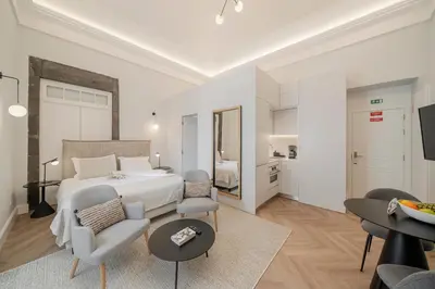 a bedroom with a bed and a living room at FAA Belas Artes by An Island Apart in Funchal