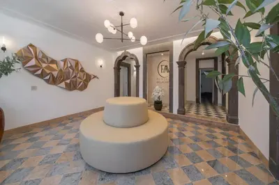 a lobby with a round table in the middle of a room at FAA Belas Artes by An Island Apart in Funchal