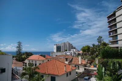 a kitchen with stainless steel appliances and a window at Madeira Precious Penthouse in Funchal
