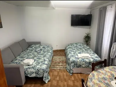 a living room with two beds and a couch at Quintinha dos Reis in Funchal