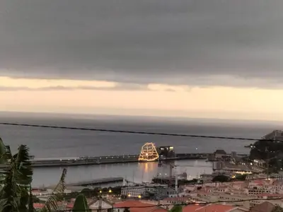 a view of a bridge over the water at dusk at Quintinha dos Reis in Funchal