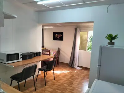 a kitchen with a table and chairs in a room at Quintinha dos Reis in Funchal