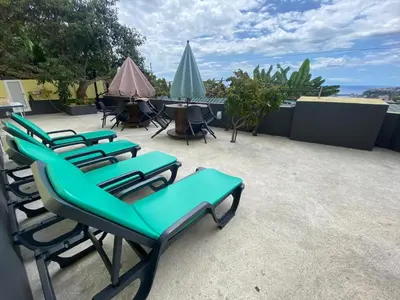 a row of chairs and tables on a patio at Quintinha dos Reis in Funchal