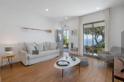 a living room with a white couch and a table at Lazareto Mar by An Island Apart in Funchal