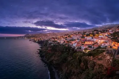 an aerial view of a town on the coast at night at Lazareto Mar by An Island Apart in Funchal