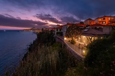 a view of a town with the ocean at night at Lazareto Mar by An Island Apart in Funchal