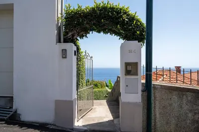 an entrance to a house with an open door with a gate at Lazareto Mar by An Island Apart in Funchal