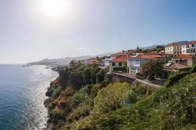 a group of houses on a hill next to the ocean at Lazareto Mar by An Island Apart in Funchal
