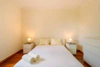a bedroom with a large white bed with two night stands at Ponta do Sol Amazing 3 Bedroom Apartment in Ponta do Sol