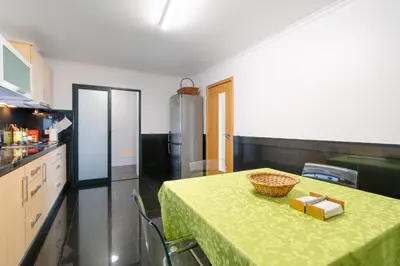 a kitchen with a table with a green table cloth at Ponta do Sol Amazing 3 Bedroom Apartment in Ponta do Sol