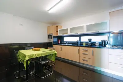 a kitchen with a table with a green cloth on it at Ponta do Sol Amazing 3 Bedroom Apartment in Ponta do Sol