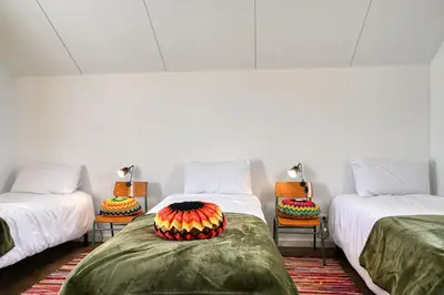 a room with three beds with a cake on them at O Lagar do Avô, a Home in Madeira in São Jorge