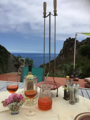 a table with two glasses of wine on a table at Villa Sophia by ALMA Holiday Rentals in Caniço