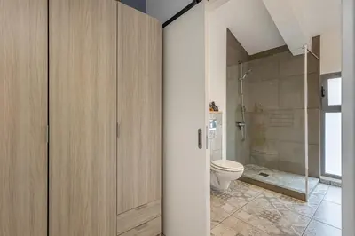 a bathroom with a toilet and a shower at Villa Sophia by ALMA Holiday Rentals in Caniço