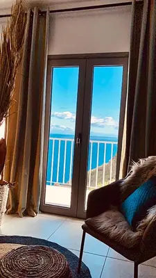 a room with a window with a view of the ocean at Villa Sophia by ALMA Holiday Rentals in Caniço