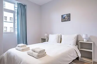 a bedroom with a white bed with towels on it at CASA DA ROCHINHA in Funchal