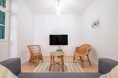a living room with a couch and chairs and a tv at CASA DA ROCHINHA in Funchal